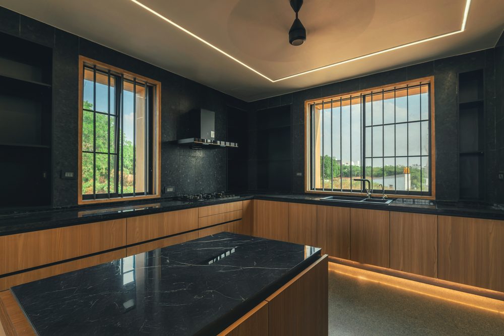 Black Rock House — Kitchen in black stone and teak